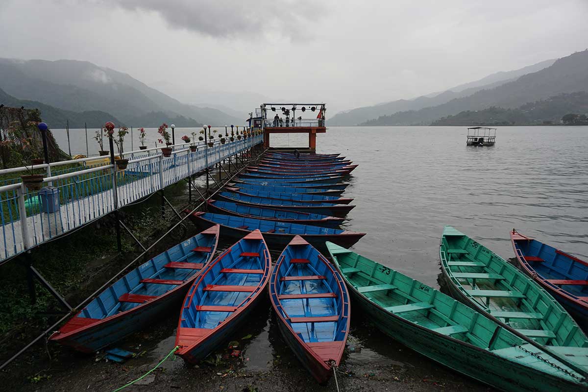 photo of boates on a late in Pokhara, Nepal